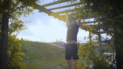 Slowmotion-shot-of-a-muscular-athlete-doing-pull-ups-in-an-archway