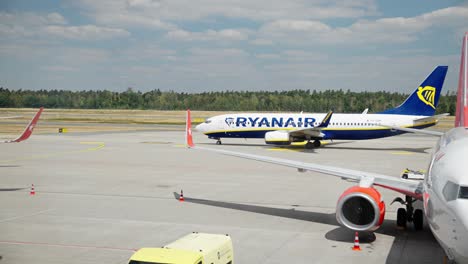 Raynair-machine-drives-by-on-runway-at-Nuremberg-Airport-surround-by-trees