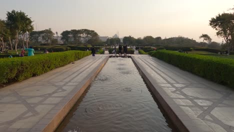 Tilt-up-from-man-made-fountain-in-the-gardens-of-Al-Azhar-Park,-Cairo-Scenic-public-space,-Sunset-mood