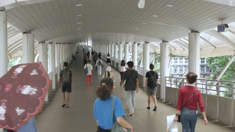 view-on-skywalk-leads-to-BTS-Train-station-at-Sathorn-Area-with-business-men-and-women