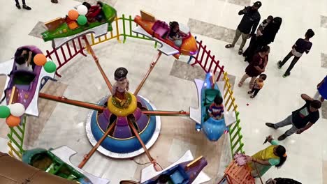 Manually-Operated-Kids-Small-Jhula-or-Jhoola-Seen-in-Mall-Mumbai-India-tiny-toy---Rocket-Token-Toys-Jhoola-For-Kid-Round-And-Round-Jula-Seen-In-Mall