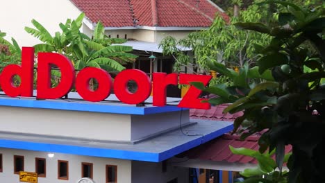 Rembang,-Indonesia--September-12,-2022:-neonbox-of-Reddoorz-popular-hotel-chain