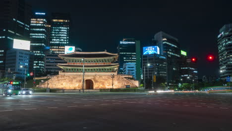Namdaemun-gate-and-Seoul-city-Night-traffic-time-lapse-at-crossroads-with-urban-skyline