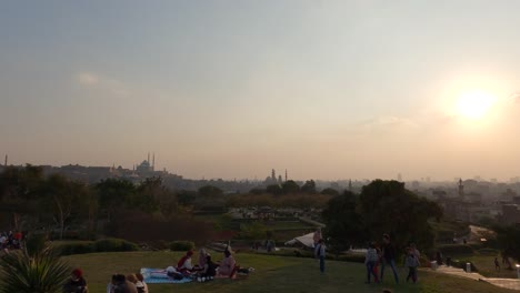 People-resting-and-enjoying-a-beautiful-Al-Azhar-Park,-city-view-from-an-overlook-in-the-park,-Cairo