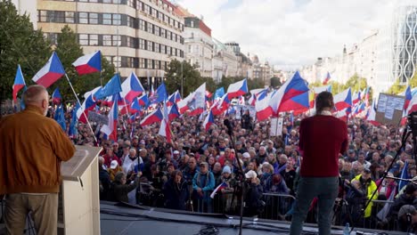 Speaker-agitating-on-stage-before-crowd-at-demonstration-in-Prague