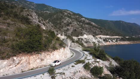 Car-driving-on-the-peaceful-roads-at-Kozjak-Lake-on-a-beautiful-sunny-day-with-blue-skies