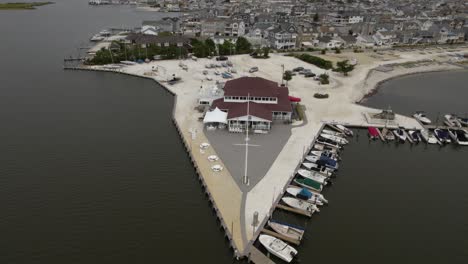 Aerial-view-approaching-the-Lavallette-Yacht-Club,-in-cloudy-New-Jersey,-USA