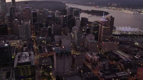 Aerial-view-around-the-Illuminated-downtown-of-Vancouver,-Canada---panoramic,-drone-shot