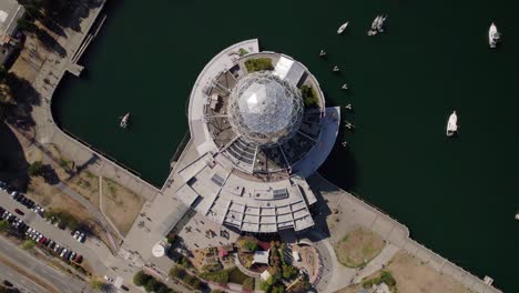 Aerial-view-of-the-Science-World-and-boats-moored-on-the-False-creek,-in-Vancouver,-Canada---rotating,-birdseye,-drone-shot