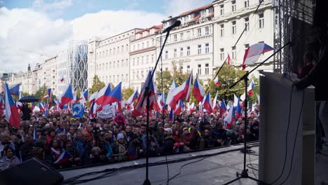 Crowd-with-czech-flags-listening-to-speaker-at-demonstration-in-Prague