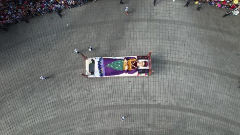 Decorated-vehicle-with-a-woman-lying-on-her-death-bed-at-the-Day-of-the-dead-Parade,-in-Mexico-city---cenital,-aerial-view