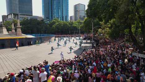 Crowd-watching-people-in-colorful-costumes-dancing-at-the-Dia-de-Muertos-parade,-in-Mexico-city---Aerial-view