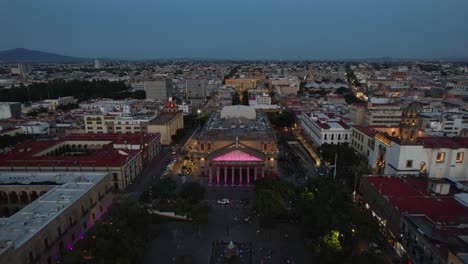 Teatro-Degollado-theater,-dusk-in-Guadalajara,-Mexico---approaching,-aerial-view