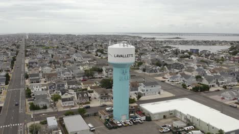 Aerial-view-around-the-watertower-in-cloudy-Lavallette,-NJ,-USA---orbit,-drone-shot