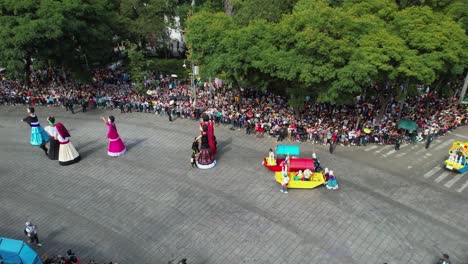 Aerial-view-overlooking-big-dolls-and-parade-wagons-at-the-Dia-de-los-Muertos-march-in-Mexico-city