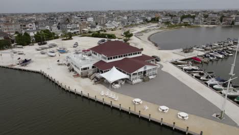 Aerial-view-around-the-Lavallette-Yacht-Club,-in-New-Jersey,-USA---rotating,-pull-back,-drone-shot
