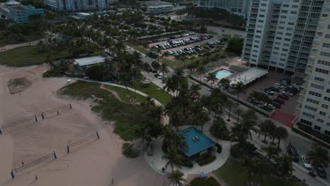Aerial-View,-Pompano-Beach-FL-USA-Cityscape-Skyline,-Beachfront-Buildings,-Canal-and-Ocean-Horizon,-Drone-Shot,-Parking-in-Lot