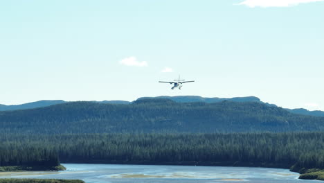 Stunning-wide-angle-view-of-a-seaplane-coming-in-to-land-near-a-large-river-in-Labrador,-Canada