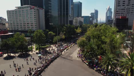 Aerial-view-around-the-empty-parade-route-on-Reforma-Avenue,-in-sunny-Mexico-city---circling,-drone-shot