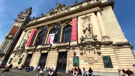 People-Sitting-And-Hanging-Out-On-Stairs-At-The-Entrance-Of-Lille-Opera-During-Midday-In-France