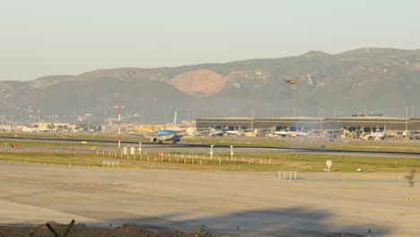 Pequeño-Avión-Klm-Aterriza-En-El-Aeropuerto-De-Barcelona-Al-Amanecer,-Tiro-De-Seguimiento,-Cacerola