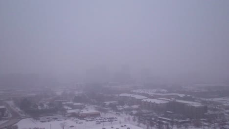 Aerial-view-pushing-towards-downtown-Boise,-Idaho-during-a-blizzard