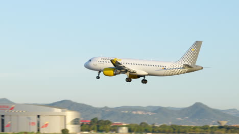 Tracking-modern-Vueling-airliner-plane-arriving-at-Barcelona-airport,-Spain