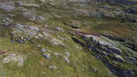 Huge-line-of-people-on-popular-mountain-hiking-trail-Dronningstien-between-Lofthus-and-Kinsarvik-in-Hardanger---Norway-aerial