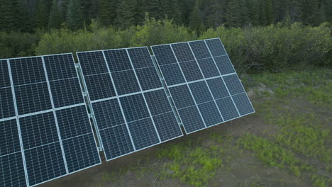 Gorgeous-tracking-shot-moving-over-a-row-of-Solar-Panels-in-the-woods-of-Labrador,-Canada