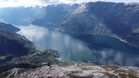 Spectacular-panoramic-fjord-view-on-cliffs-edge-at-queens-hiking-trail-above-Lofthus-in-Hardanger-Norway---Sorfjorden-Hardangerfjord-view-from-mountaintop-with-people