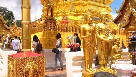 People-doing-Buddhist-prayer-at-Golden-Doi-Suthep-Temple-in-Chiang-Mai,-Thailand