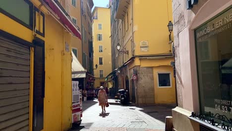 Few-People-Walking-On-The-Historical-Street-At-The-Old-Town-Of-Nice,-France