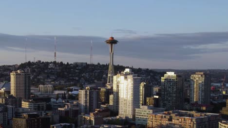 Aerial-view-rising-towards-the-Space-needle-observation-tower,-golden-hour-in-Seattle,-USA