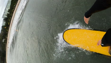 High-speed-surfing-near-people-fallen-in-water,-POV-vertical-video