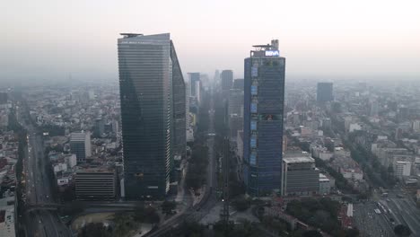 Aerial-dolly-drone-shot-over-skyscrapers-of-Mexico-City-with-The-Ritz-Carlton-Tower-and-BBVA-building-with-slow-camera-movement