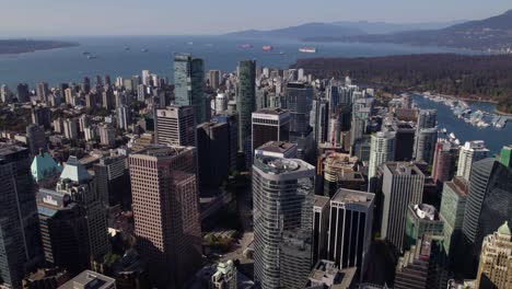Flying-in-front-of-High-rise-in-downtown-Vancouver,-British-Columbia,-Canada---Aerial-view