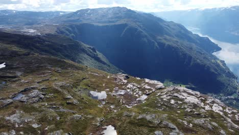 Spectacular-Hardangervidda-mountain-landscape-with-queens-hiking-trail-on-cliffs-edge-above-Lofthus-Village---Hardanger-Norway