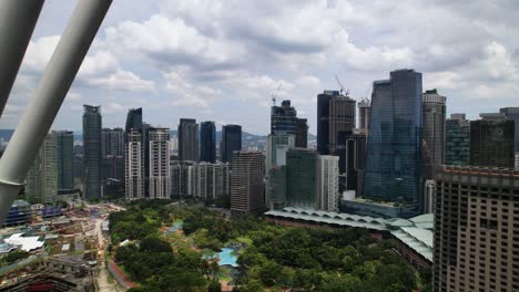 4k-Dramatic-closeup-drone-shot-flying-backwards-between-Petronas-Towers-in-Kuala-Lumpur,-Malaysia