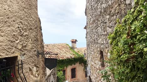 Tourists-Visiting-The-Medieval-Eze-Village-With-Cobbled-Street-And-Old-Stone-Buildings-In-France---tilt-up