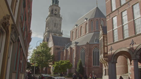 Wide-Tilt-down-of-Beautiful-Martini-Church-with-amazing-bell-tower-in-the-background-and-revealing-the-busy-streets-of-Groningen-city-in-the-Netherlands