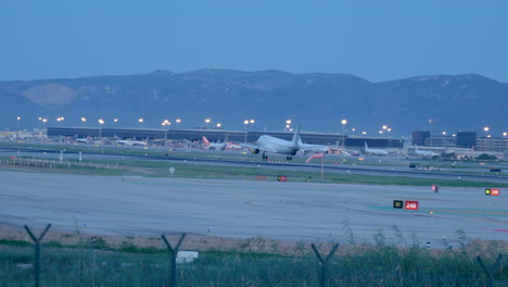 Vueling-passenger-air-plane-landing-on-runway-at-blue-hour-in-Barcelona-Spain