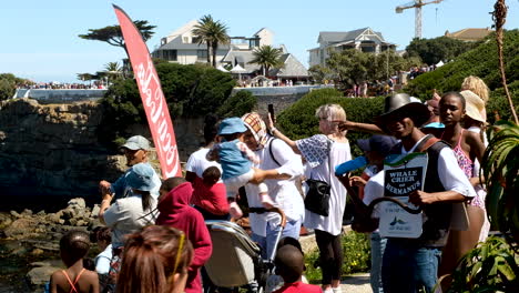 Hermanus-Whale-Crier-blowing-on-his-kelp-horn-among-people-at-whale-festival