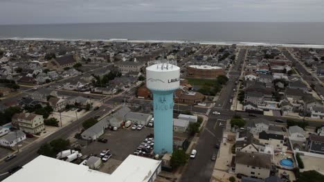 Aerial-view-around-the-water-tower-in-cloudy-Lavallette,-New-Jersey,-USA---orbit,-drone-shot