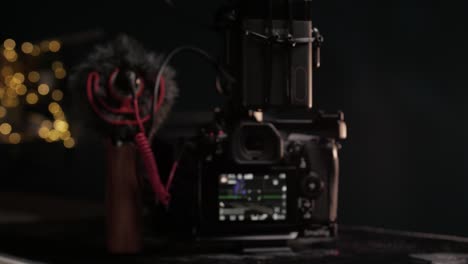 Dolly-in-and-coming-into-focus-shot-of-a-Panasonic-G9-cinema-camera-with-a-high-quality-microphone