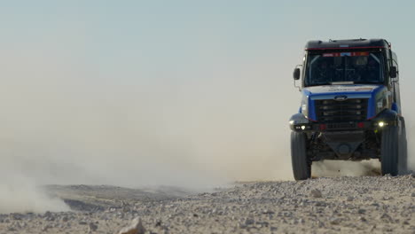 Car-racing-truck-speeding-cross-country-in-dry-Dakar-desert-off-road-rally-trail