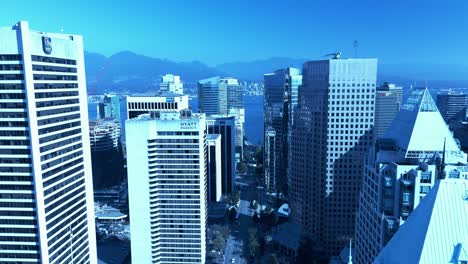 Vancouver-sunny-summer-day-closeup-flyover-Burrard-street-Fairmont-hotel-rooftop-aligning-with-Citadel-triangle-roof-aerial-drone-reverse-flyout-YVR1-4