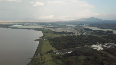 4k-aerial-view-of-the-shore-of-Lake-Naivasha,-Sulmac-Village,-Kenya