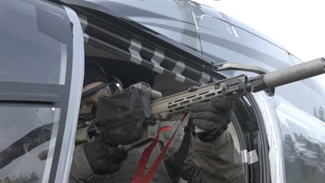 Soldier-With-Sniper-Rifle-in-Helicopter-Pointing-at-Target,-Close-Up