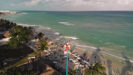 Aerial-View-Of-Danza-De-Los-Voladores-Performance-By-The-Beach-In-Mexico