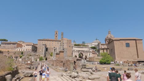 Tourists-Sightseeing-Around-The-Roman-Forum-On-Sunny-Day-With-Clear-Blue-Skies